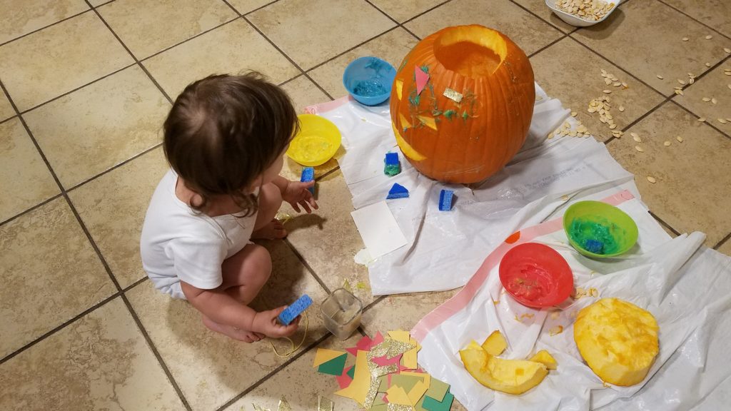 Mama Rissa's toddler decorating her pumpkin as an example of the many ways to carve a pumpkin with your toddler.