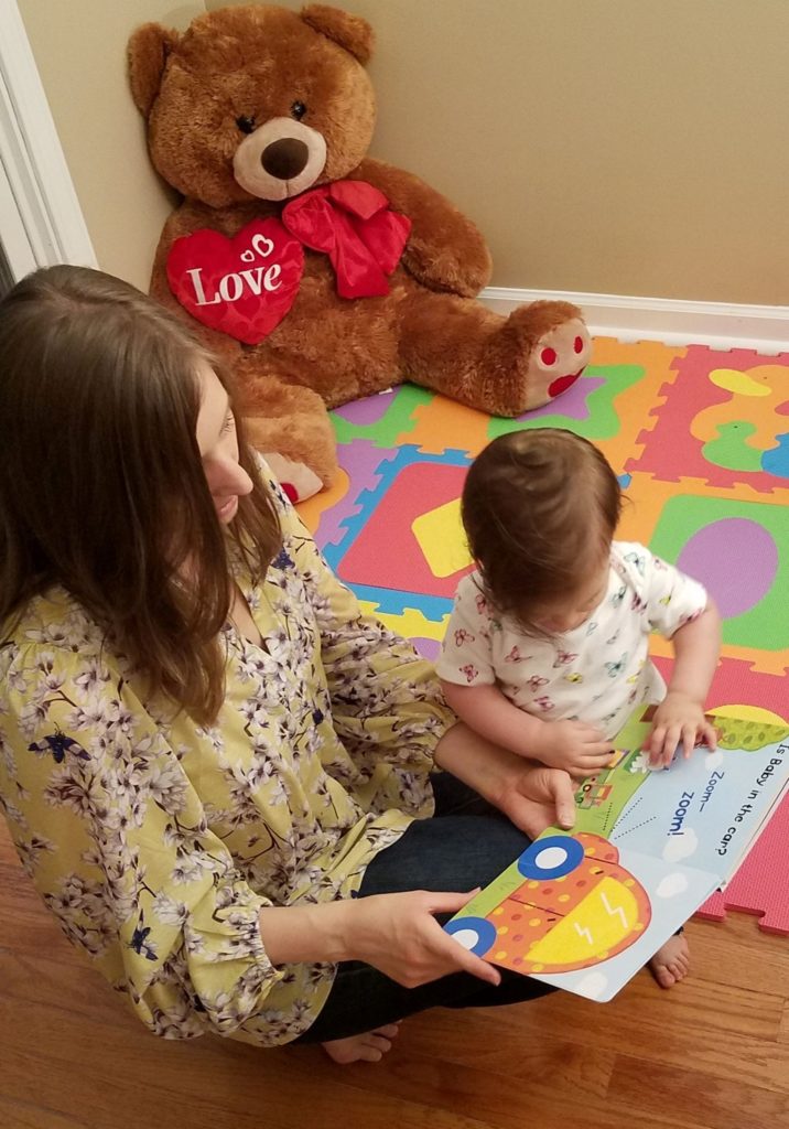 Mama Rissa reading to her daughter as a stay-at-home mom. 