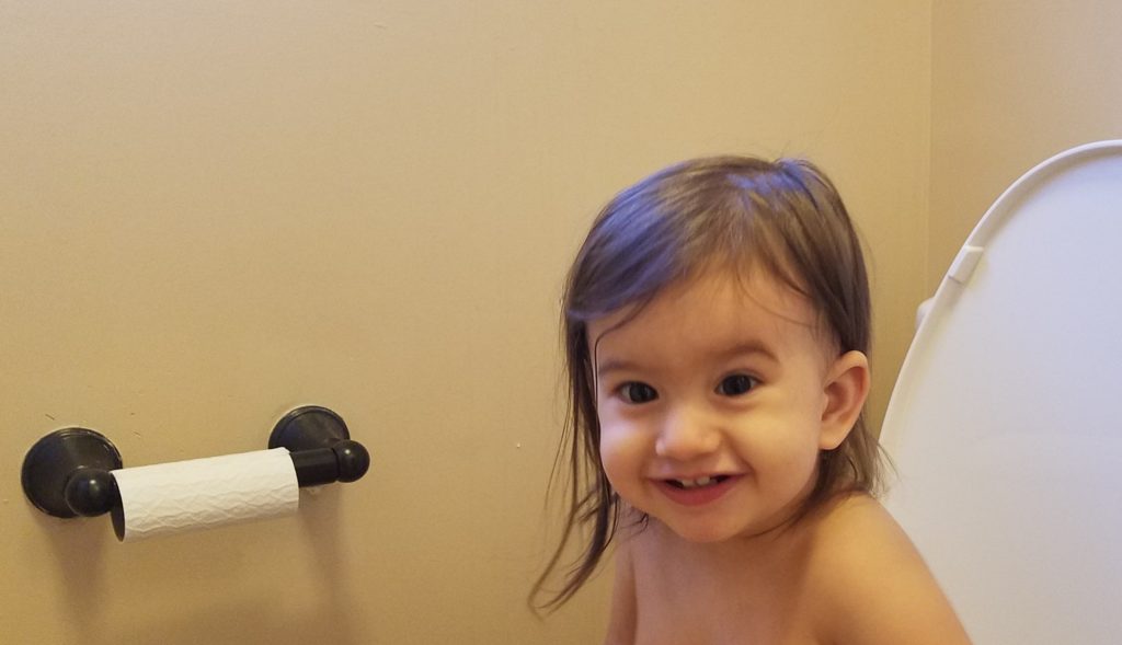 Mama Rissa's daughter potty training on the toilet.