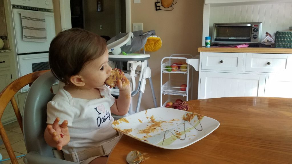 Mama Rissa's daughter eating bread.