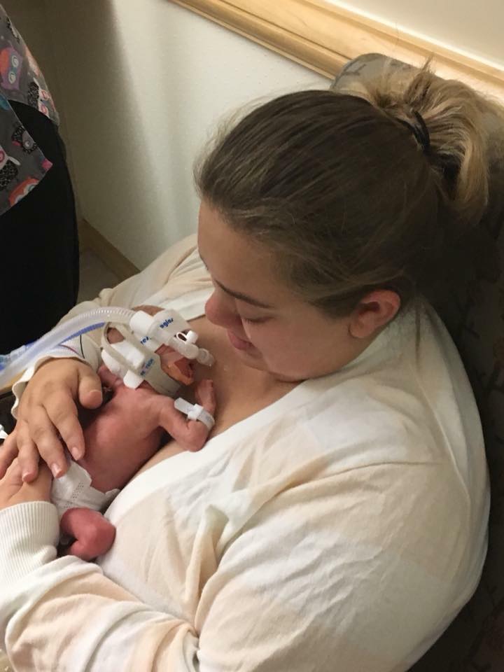 Katie holding her preemie baby girl.