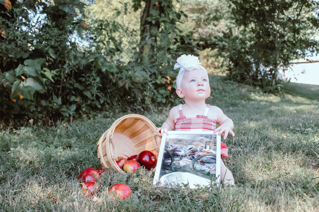 Katie's 1-year-old daughter sitting outside.