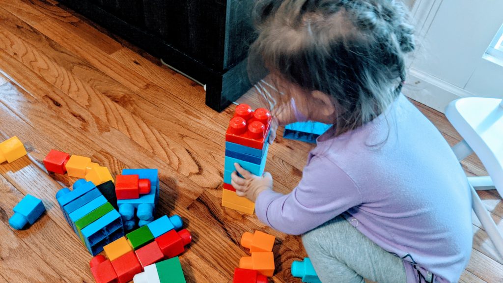 Mama Rissa's daughter practicing her block building.