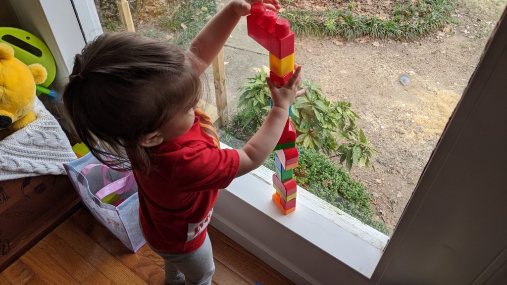 Mama Rissa's daughter building with blocks.
