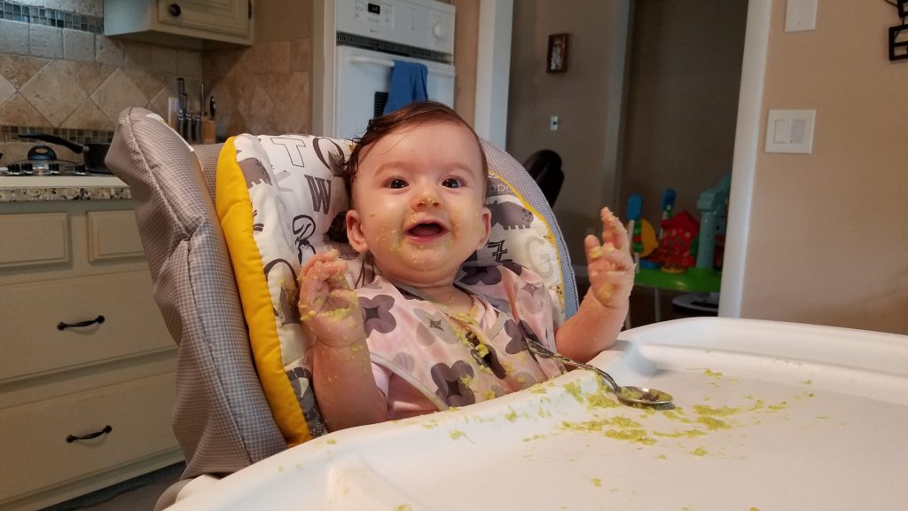 Mama Rissa's baby eating in her highchair demonstrating how to start solids.