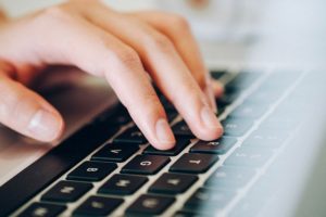 Hand typing on computer keyboard. 