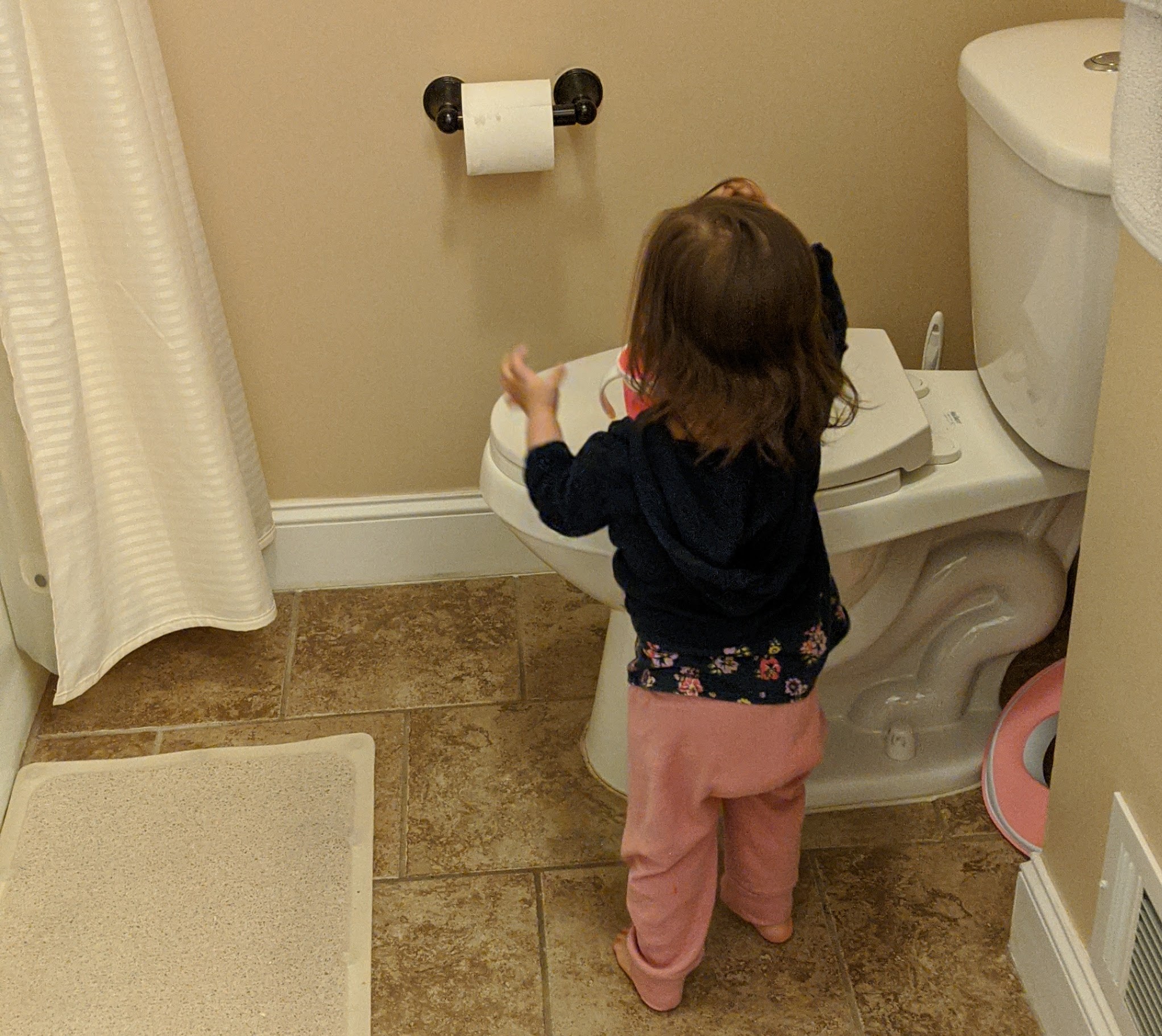 Mama Rissa's toddler standing by the potty.