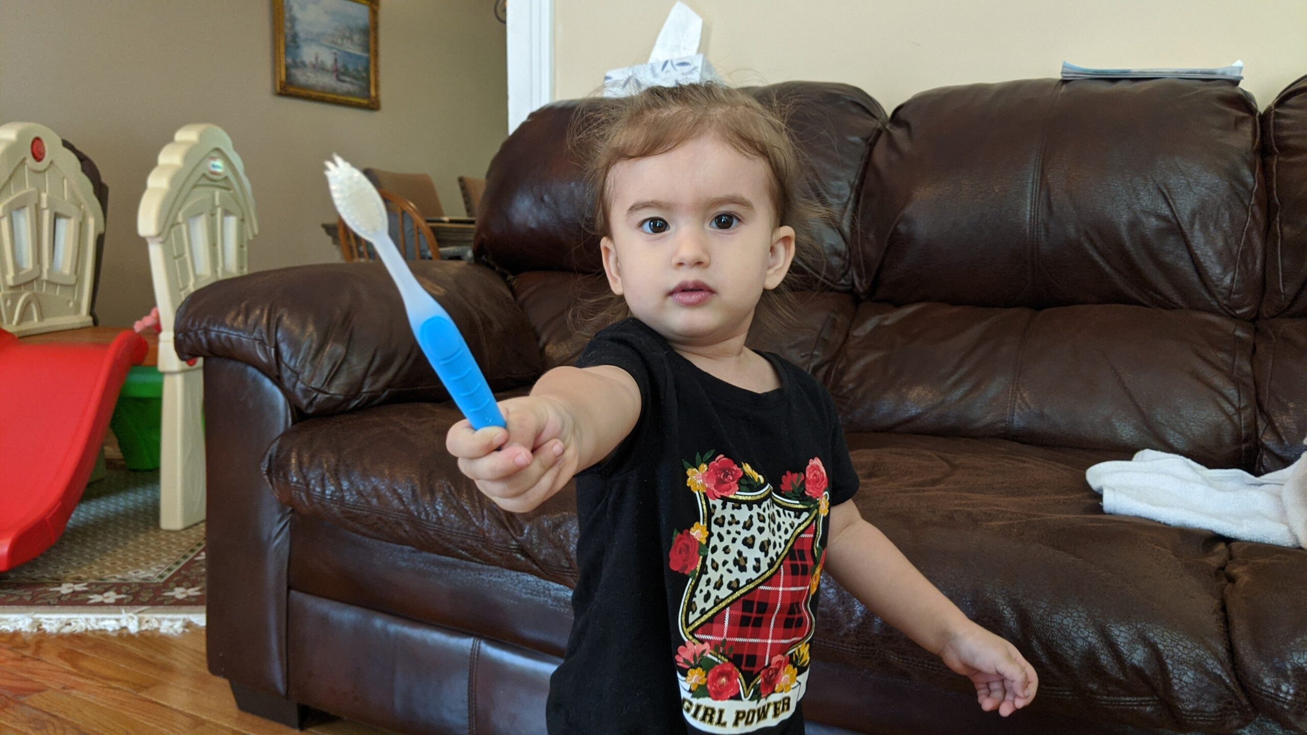 Mama Rissa's toddler holding a toothbrush