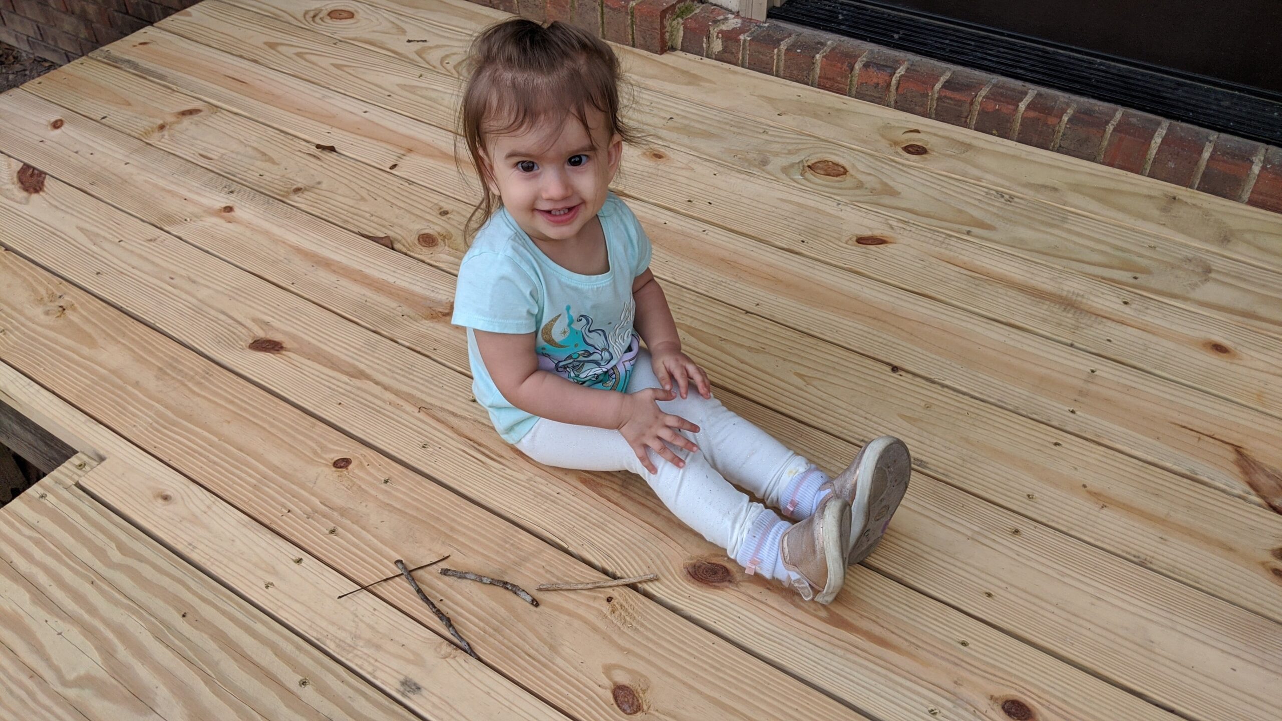 Mama Rissa's daughter sitting on porch.