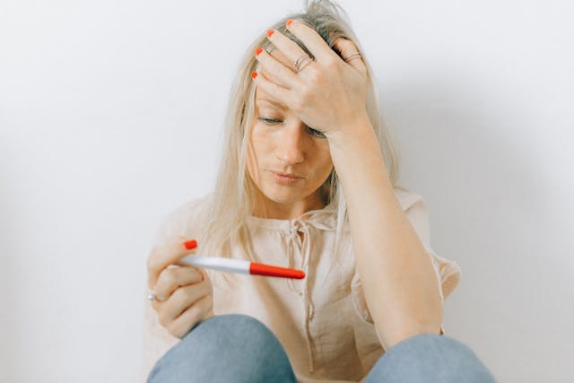 Woman staring at a pregnancy test