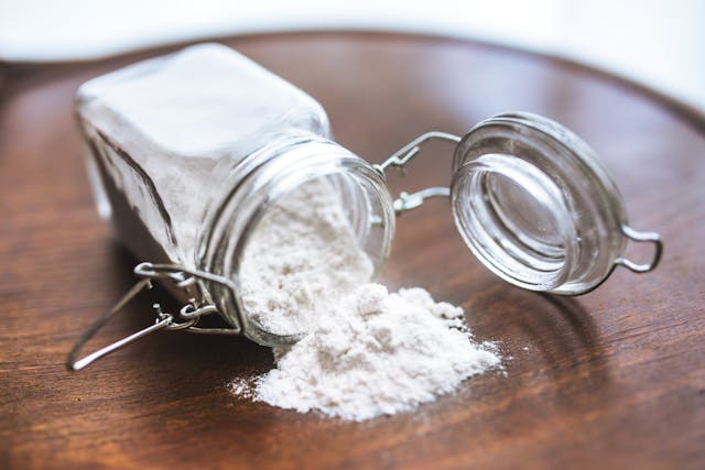 Tooth powder spilling out of a jar