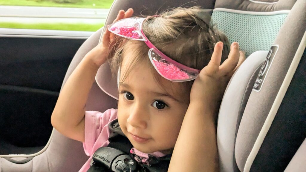 Mama Rissa's daughter playing in the car with an animal ears headband